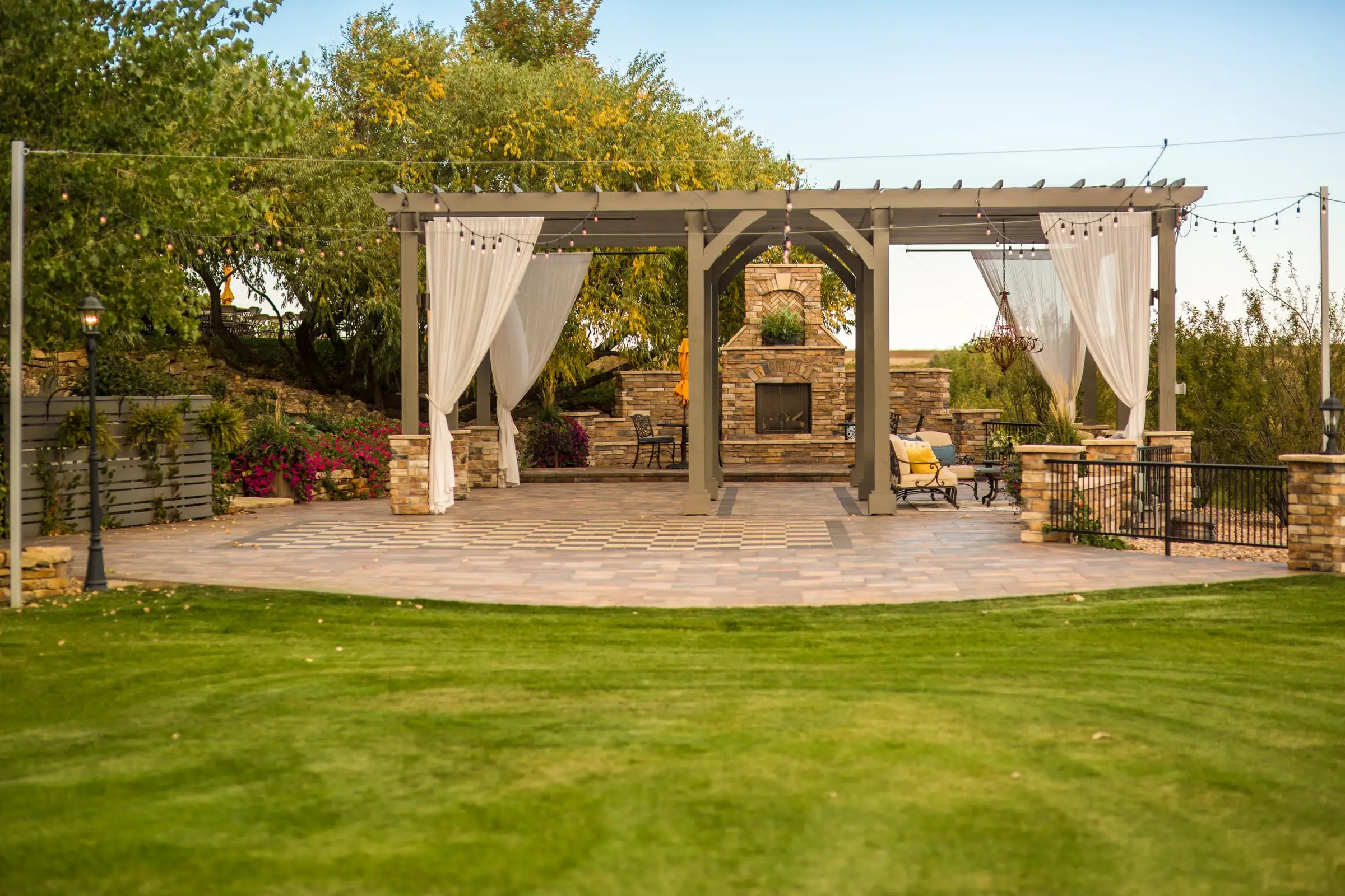 The pergola-covered patio with the stone hearth